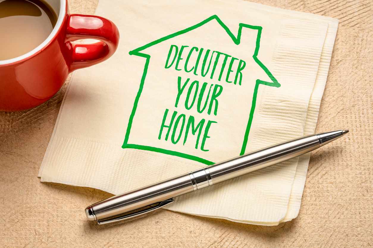 A napkin with a sketch of a house that reads "declutter your home."